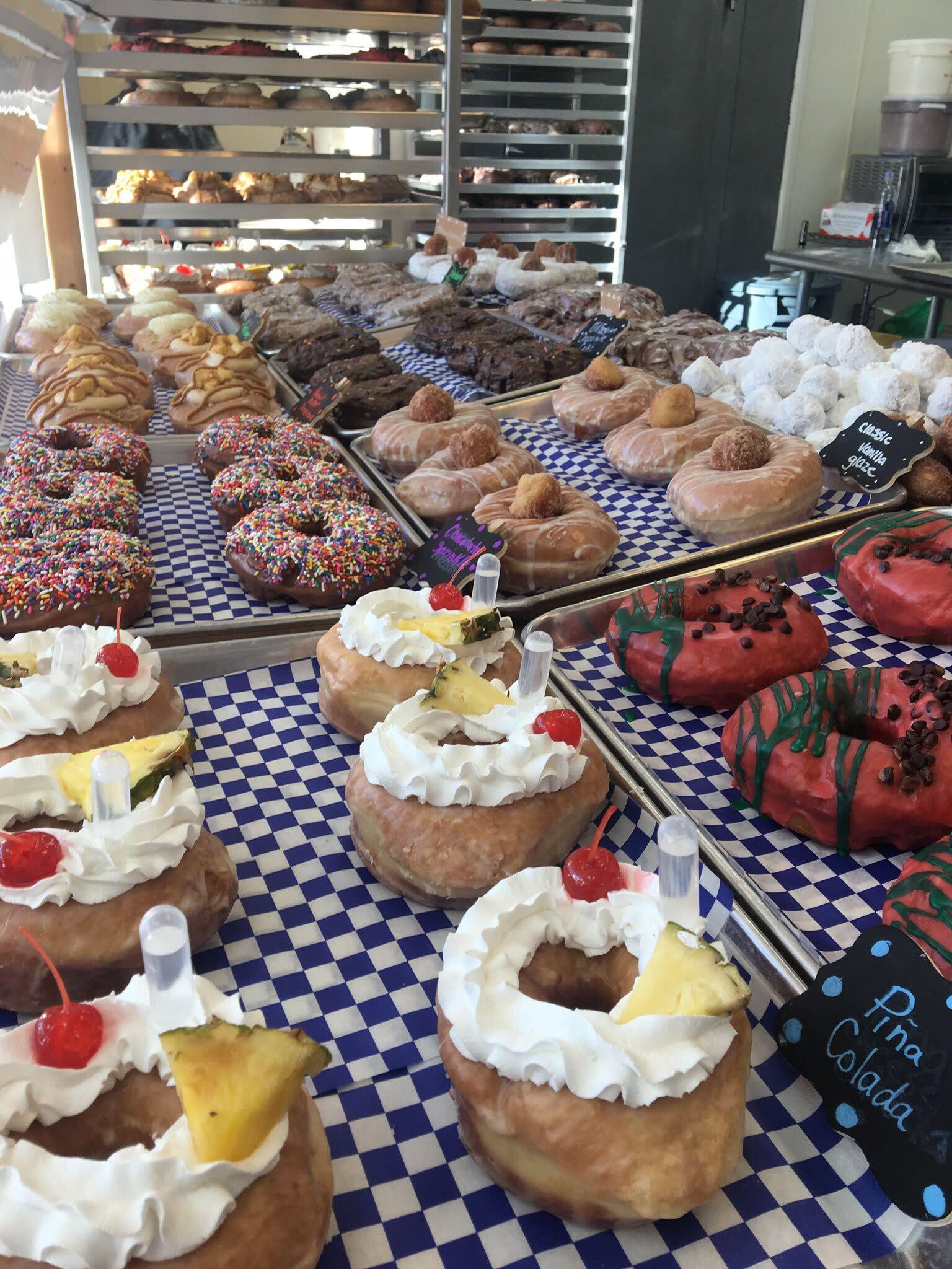 A tray of filled doughnuts in the case