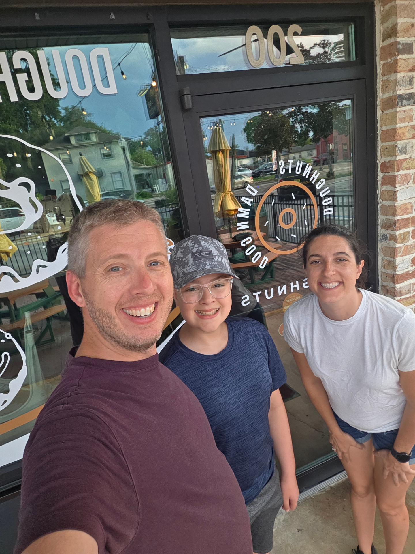 Christy, Nick and their son outside the DG Doughnuts shop on McKey Street in Ocoee
