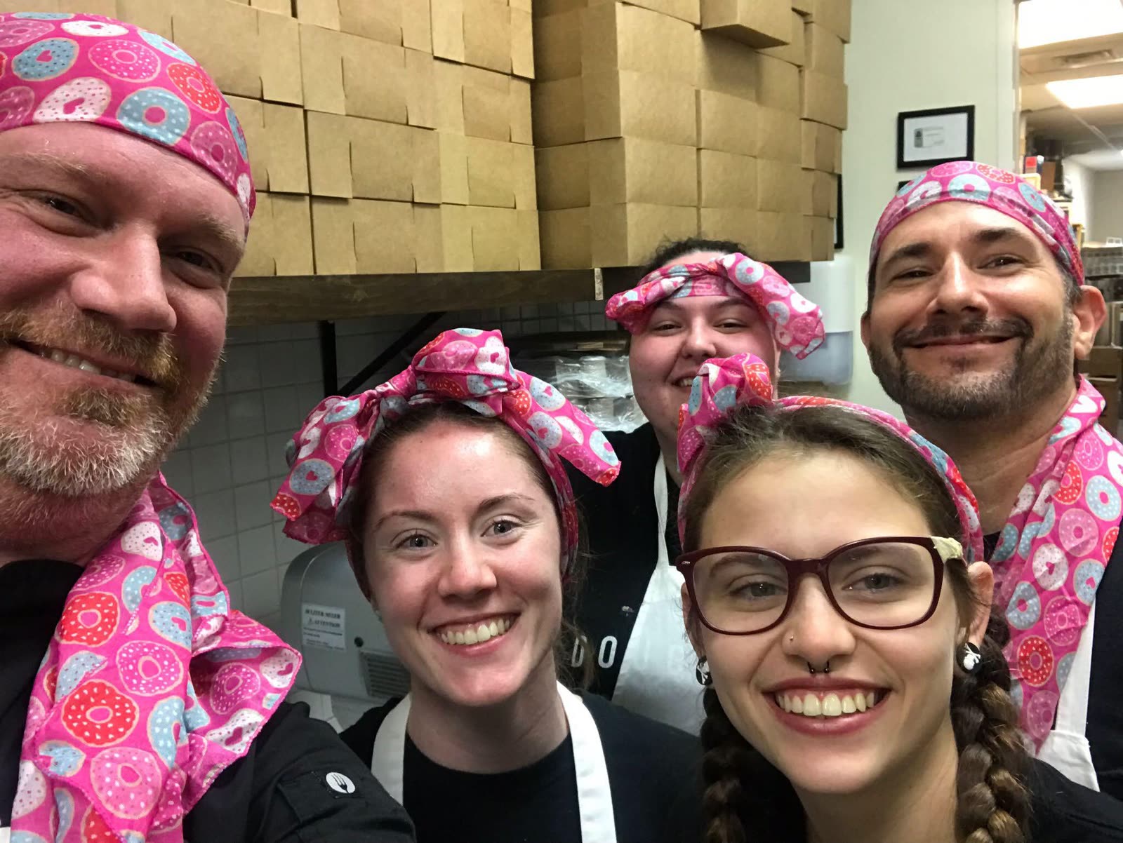 Nick, Christy and the Damn Good team in the kitchen wearing bandanas